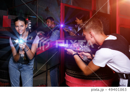 friends holding colored laser guns during laser tag game friends holding colored laser guns during laser tag game 49401863