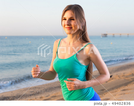 Female in blue T-shirt is jogging 49402836
