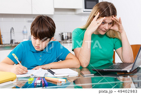 Displeased family doing homework 49402983