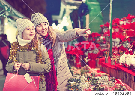 Girl with woman choosing Christmas gifts for family 49402994