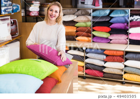 Young female customer is choosing new pillow 49403505