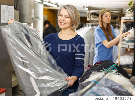 Portrait of female laundry customer Portrait of female laundry customer 49403578