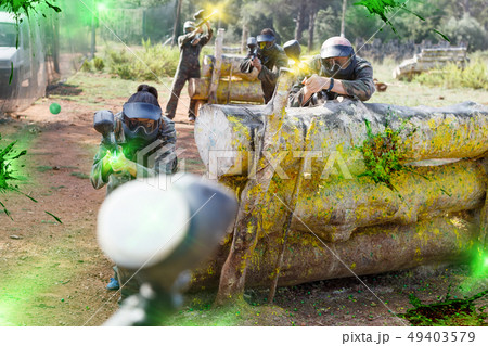 Paintball players playing outdoors 49403579