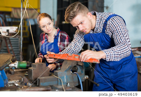 Happy man is working with level on his workplace Happy man is working with level on his workplace 49403619