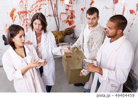 Young people in lost room with bloody walls 49404459