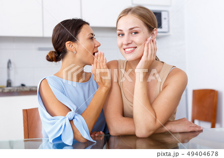 Women friends whispering emotionally 49404678
