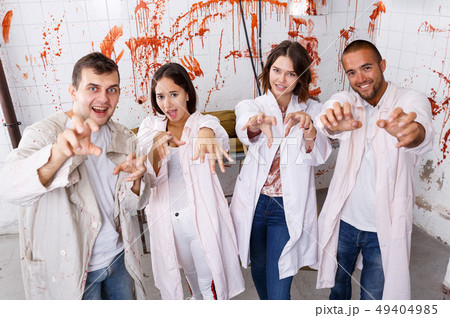 Young adults posing as zombies 49404985