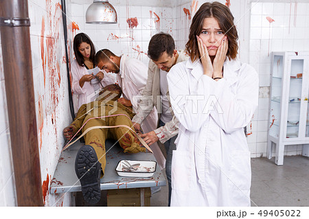 Frightened girl in escape room stylized as medical room 49405022