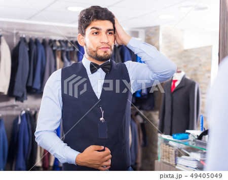 Customer is trying on chosen image in front of the mirror 49405049