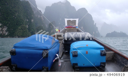 Tourist wooden boat with a suitcases in cloudy weather in Khao Sok national park, Thailand 49406919
