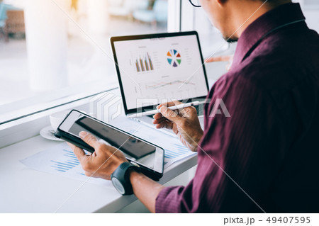 Investors man holding pen pointing tablet to 49407595