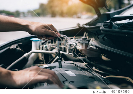 Car mechanic is holding a wrench ready to check 49407596
