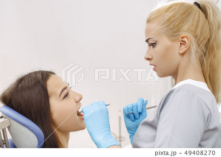 Surprised dentist looking at patient mouth 49408270