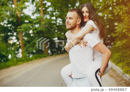 Beautiful couple spend time in a summer park Beautiful couple spend time in a summer park 49408867