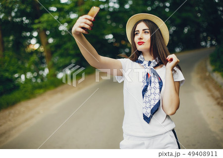 Cute girl walking in a summer park Cute girl walking in a summer park 49408911