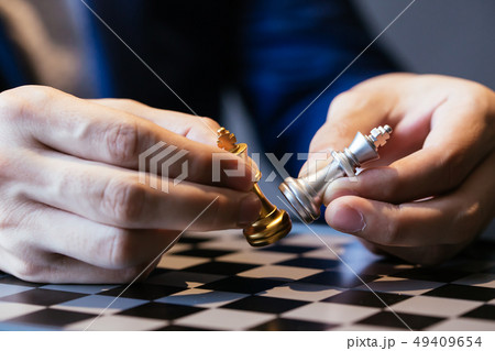 Cropped image of businessman made chess pieces fight 49409654
