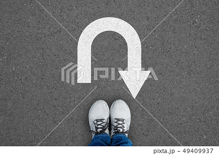 White shoes standing at the u turn sign White shoes standing at the u turn sign 49409937