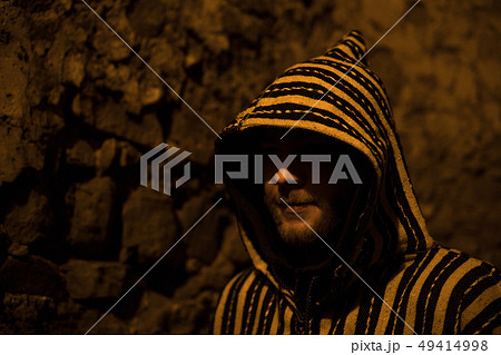 Man in Traditional moroccan djellaba on the Night street of Asilah Medina, on Atlantic Coast in Man in Traditional moroccan djellaba on the Night street of Asilah Medina, on Atlantic Coast in 49414998