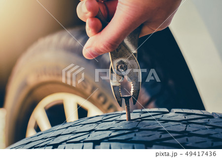 Hand pulling for Removing a Nail in the Tire,Flat tire Fixing and Repair the tire is leaking from 49417436