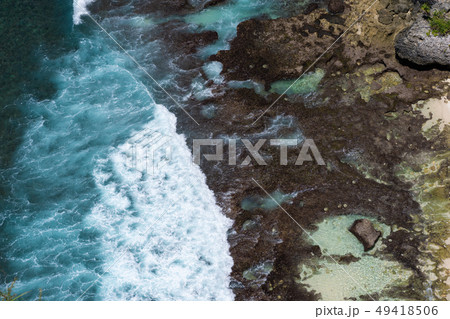 Epic aerial view of blue ocean waves crashing into 49418506