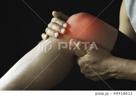 The male clings to a bad knee. The pain in his 49418611