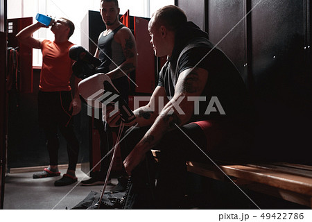 Preparation to big fight. Athletes boxers in sports clothing preparing boxing gloves for training in Preparation to big fight. Athletes boxers in sports clothing preparing boxing gloves for training in 49422786
