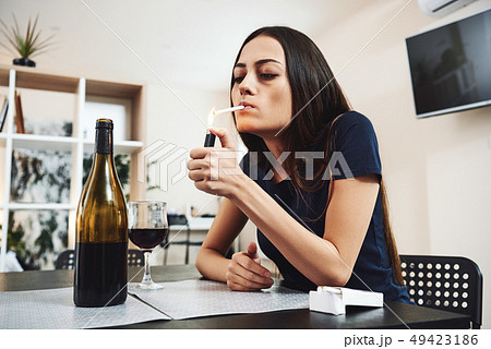 Quitting smoking is easy, I've done it hundreds of times. Young woman alcoholic, smoker, social 49423186