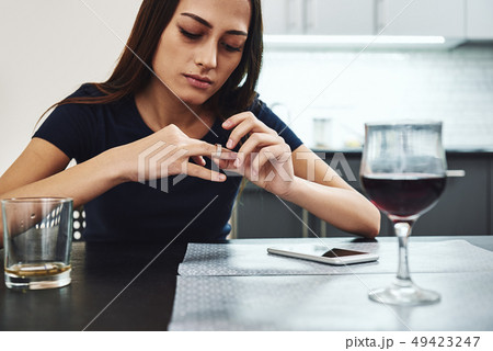 I should begin to be a friend to myself. Young woman sitting with a glass of red wine alone in I should begin to be a friend to myself. Young woman sitting with a glass of red wine alone in 49423247