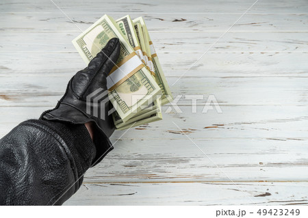 Crime Concept Man In Black Leather Gloves Holding Bricks Of Money Crime Concept Man In Black Leather Gloves Holding Bricks Of Money 49423249