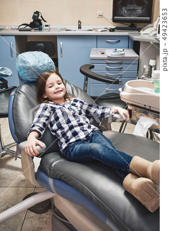 Better Doctors. Better Care. Beautiful smiling little girl in dental office, waiting for dental 49423653