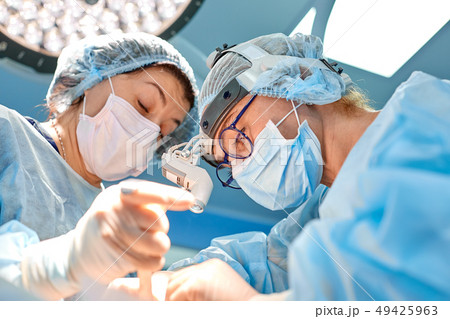 surgery, medicine and people concept - group of surgeons at operation in operating room at hospital surgery, medicine and people concept - group of surgeons at operation in operating room at hospital 49425963