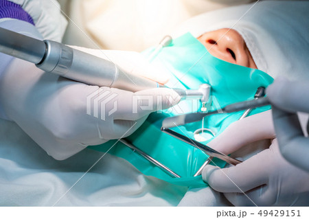Dentist hand curing patient in dental clinic 49429151