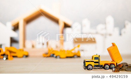 Truck model spilling gold coins on the table Truck model spilling gold coins on the table 49429159