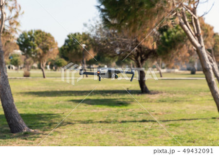 A drone with digital camera flying in the park 49432091