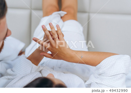 Male hand holds the female palm on light background. 49432990