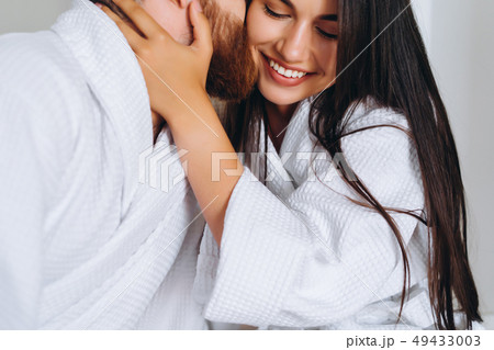 Handsome man kissing beautiful woman on cheek while Handsome man kissing beautiful woman on cheek while 49433003