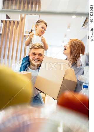 Dad mom and little son play in the bedroom with paper boxes 49433088