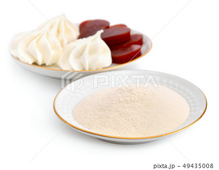 Agar-agar powder on a white plate. On a background Agar-agar powder on a white plate. On a background 49435008