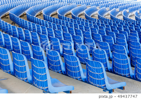 Rows of blue plastic chairs on a metal base Rows of blue plastic chairs on a metal base 49437747