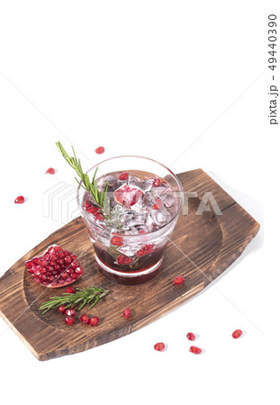 Pomegranate juice with ripe pomegranate on white 49440390