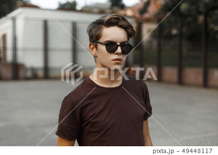 Handsome stylish man in sunglasses standing  49448117