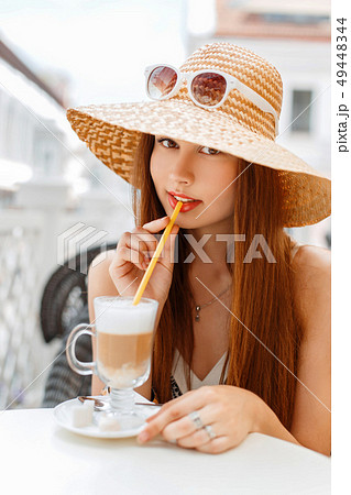 Beautiful elegant woman in a hat and sunglasses 49448344