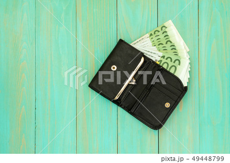 Black leather wallet full of euro banknotes Black leather wallet full of euro banknotes 49448799
