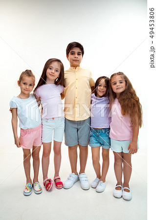 The portrait of cute little boys and girls in stylish clothes looking at camera at studio The portrait of cute little boys and girls in stylish clothes looking at camera at studio 49453806