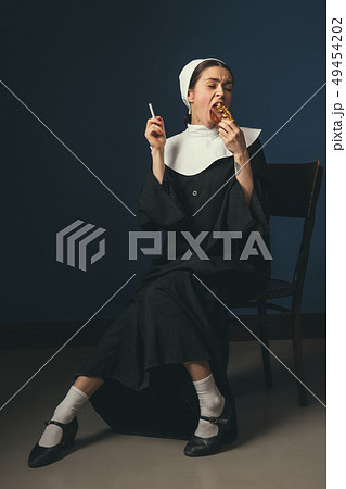 Medieval young woman as a nun 49454202