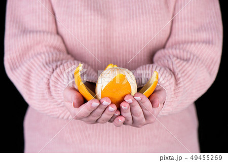 Peeled orange on the palms of a girl Peeled orange on the palms of a girl 49455269