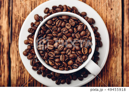 White cup full of roasted coffee beans 49455918