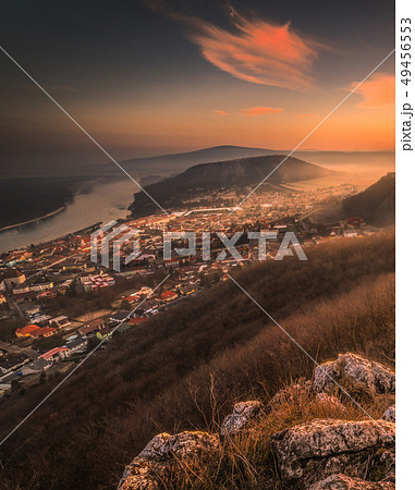 View of a Small City near a River at Sunrise 49456553