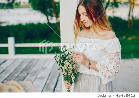 Young and pretty girl in a summer park Young and pretty girl in a summer park 49458412