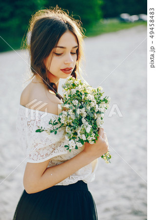 写真素材: Young and pretty girl in a summer pa